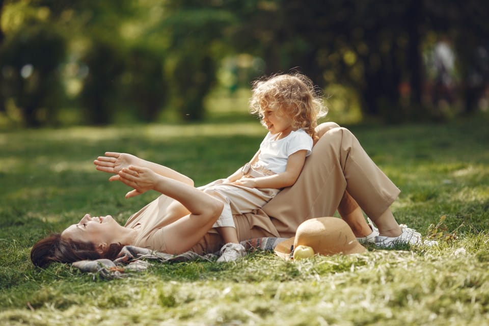 Mother and daughter relaxing in the park