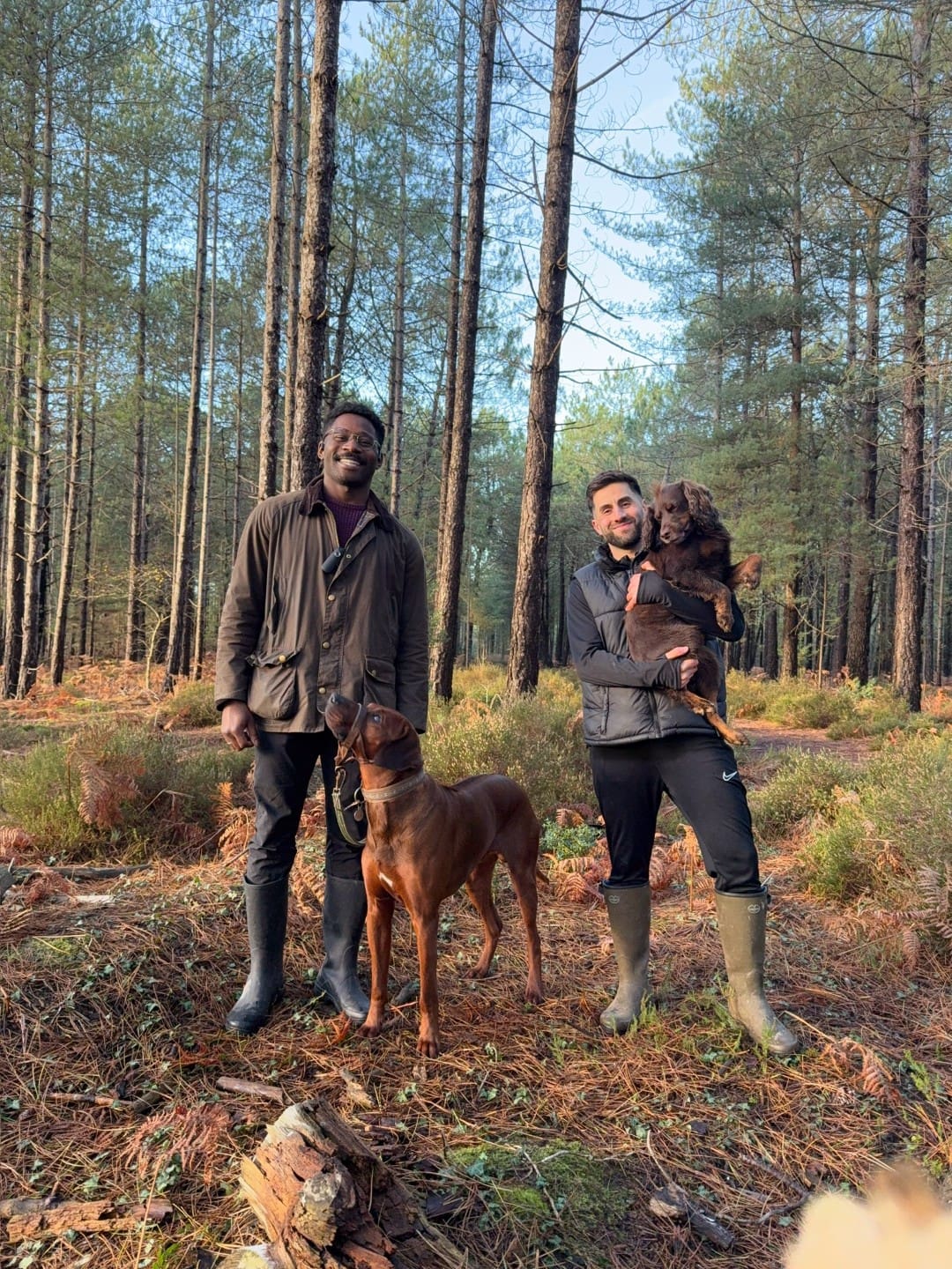 Kingsley and Louis with their dogs in the forest
