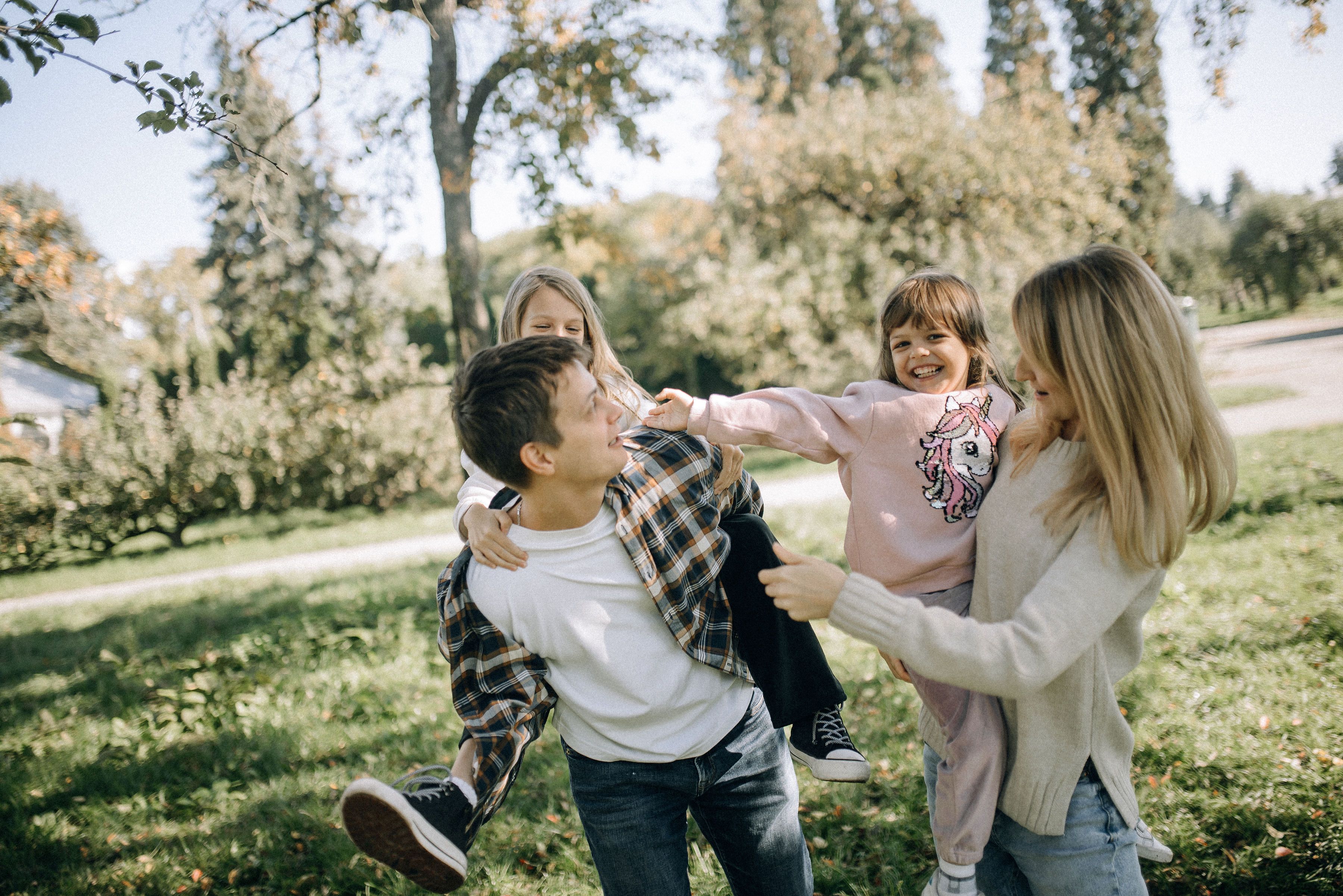 Happy family playing together outdoors in the park
