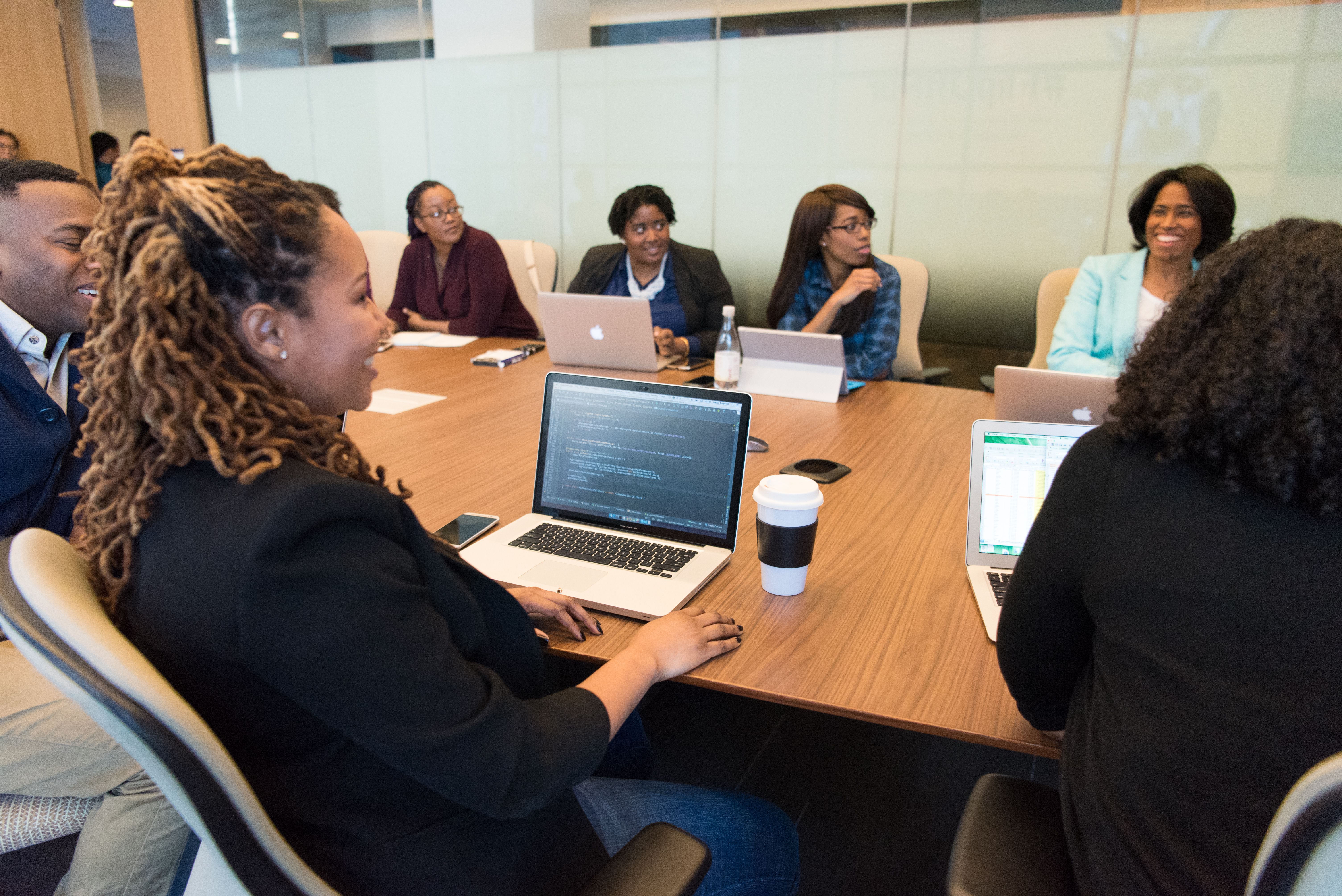 Small business employees discussing their company health insurance benefits in the office
